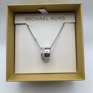 Michael Kors Silver Tone Logo Ring Pendant Necklace with Crystal Accents.
